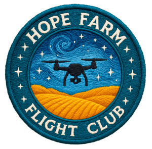 Embroidered circular patch featuring a drone flying over golden farm fields beneath a swirling starry night sky, with the words “Hope Farm Flight Club” around the border.