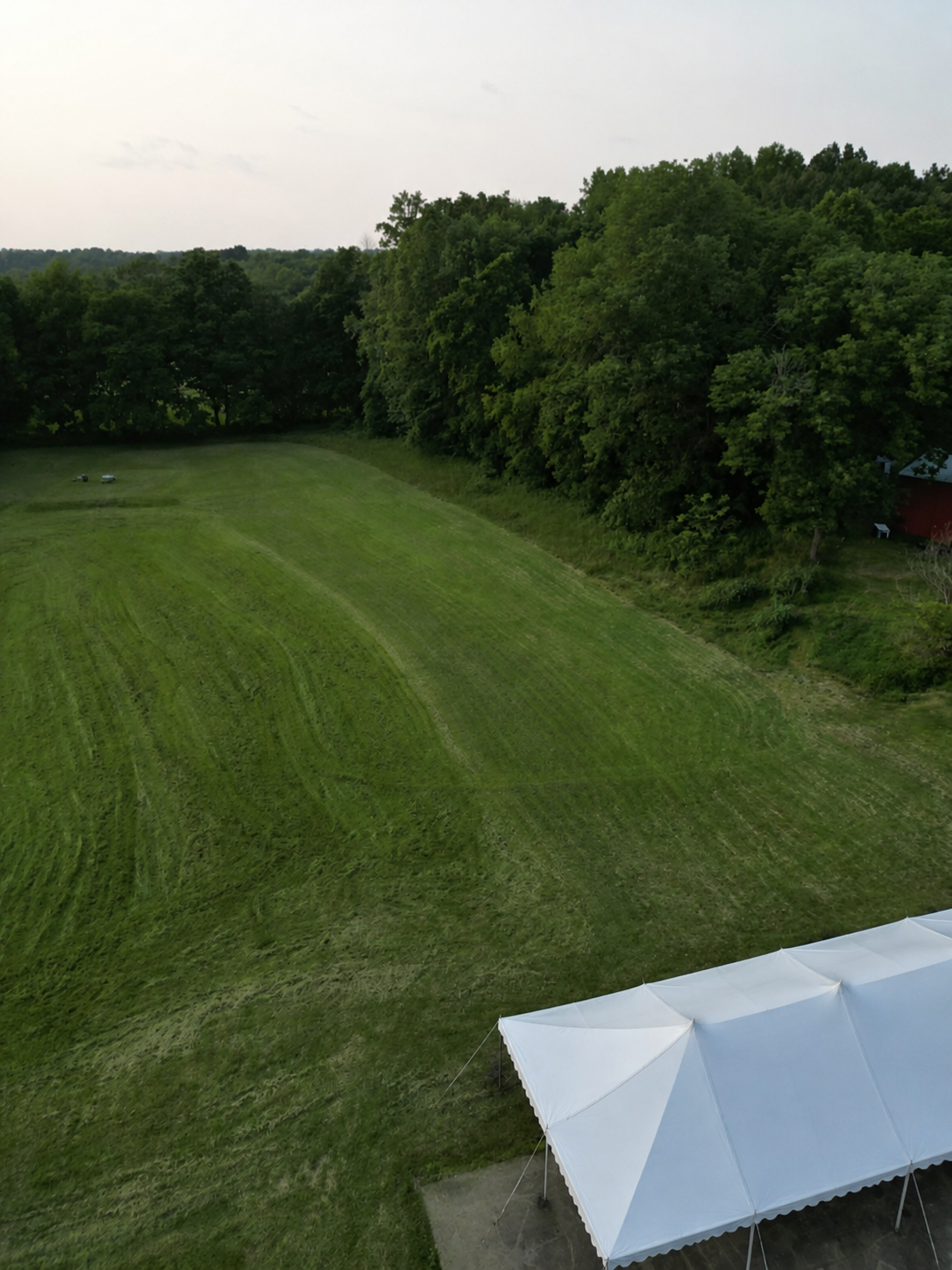 Aerial view of the Reception Pavilion and lower Retreat Commons field at Retreat at Hope Farm